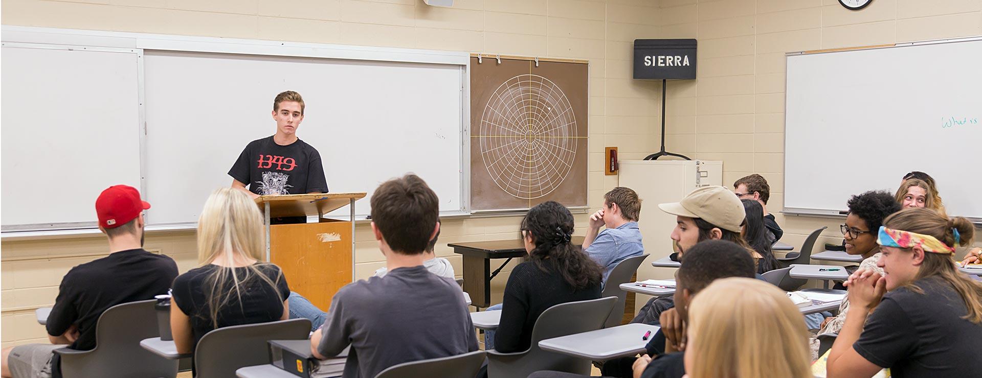 Student presenting in front of Communications Studies class