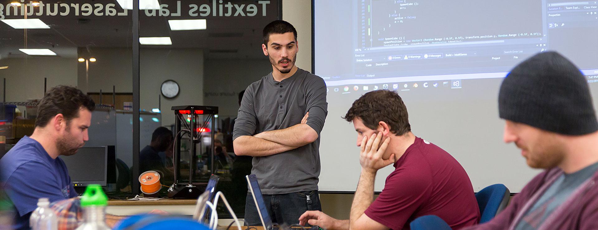 Male students working together on computer coding