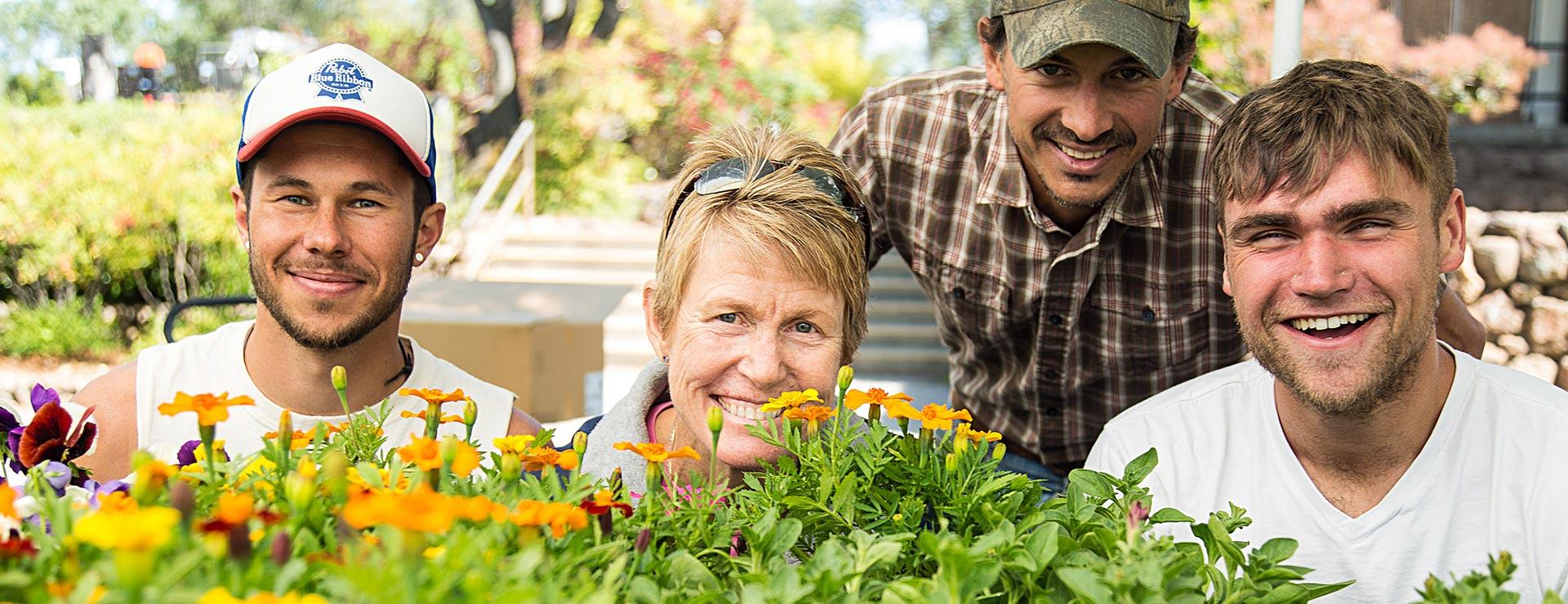 Environmental Sciences and Sustainability instructor and students learning about flowers and plant life