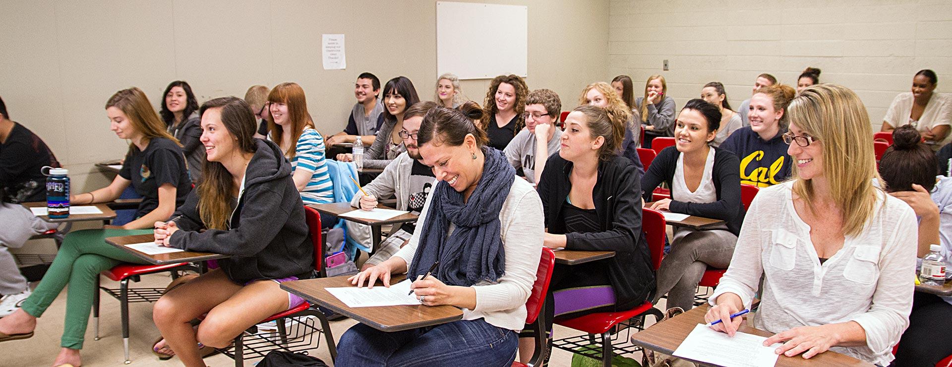 Full classroom of students facing front of classroom