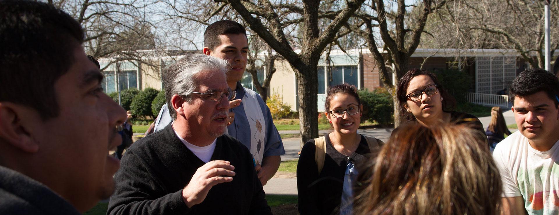 Chicana and Chicano Studies instructor teaching class outside