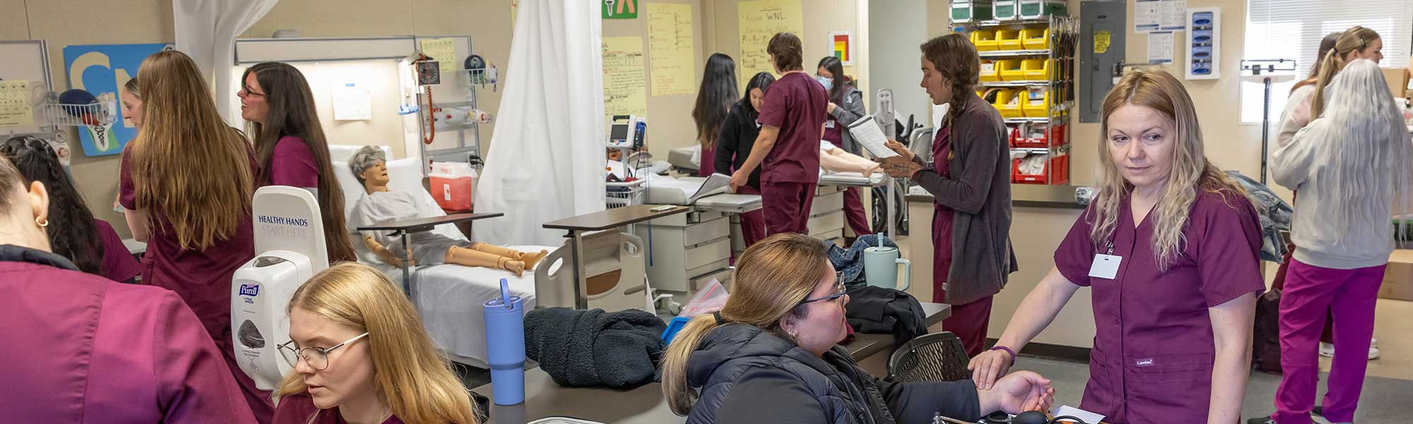 Students and instructors work together in CNA class