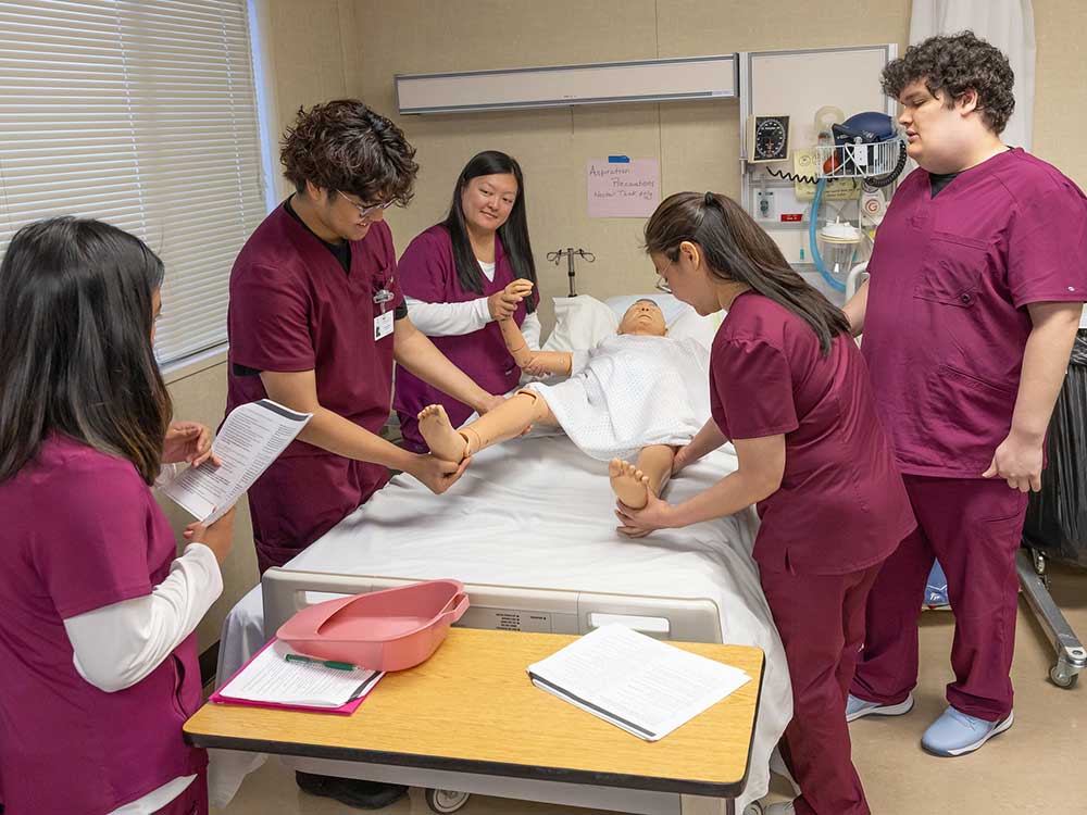 Precertification Nursing Assistant students train using a simulated patient
