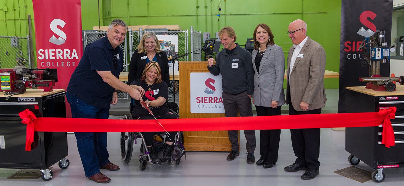 Makerspace ribbon cutting by faculty, students and executives.