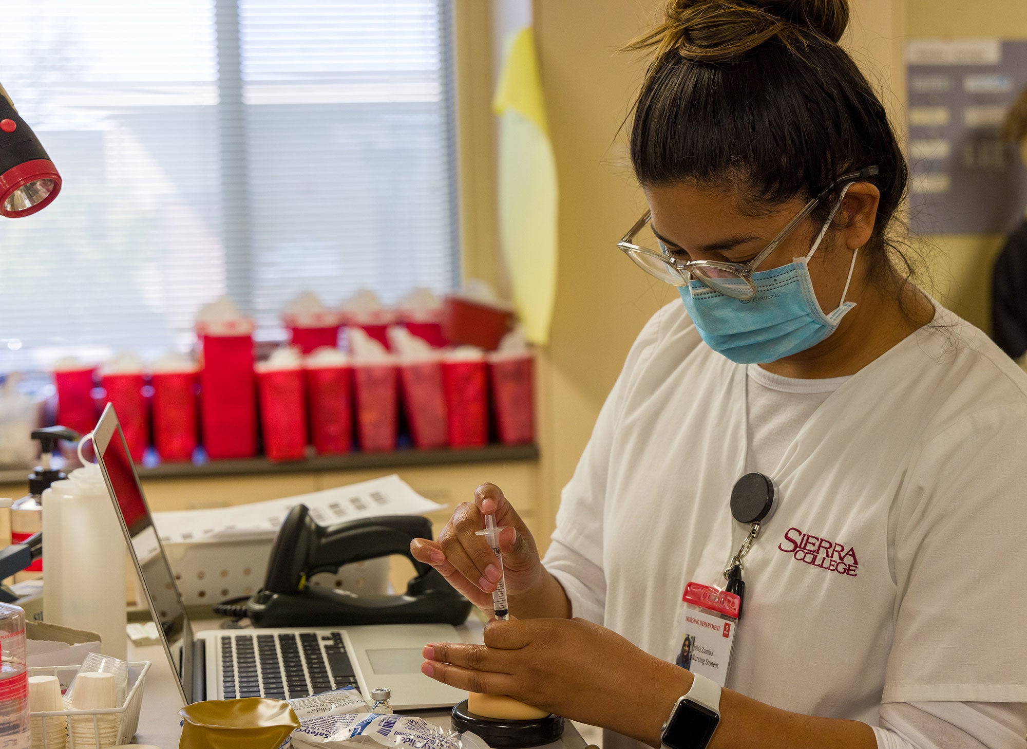 Nursing student preparing syringe
