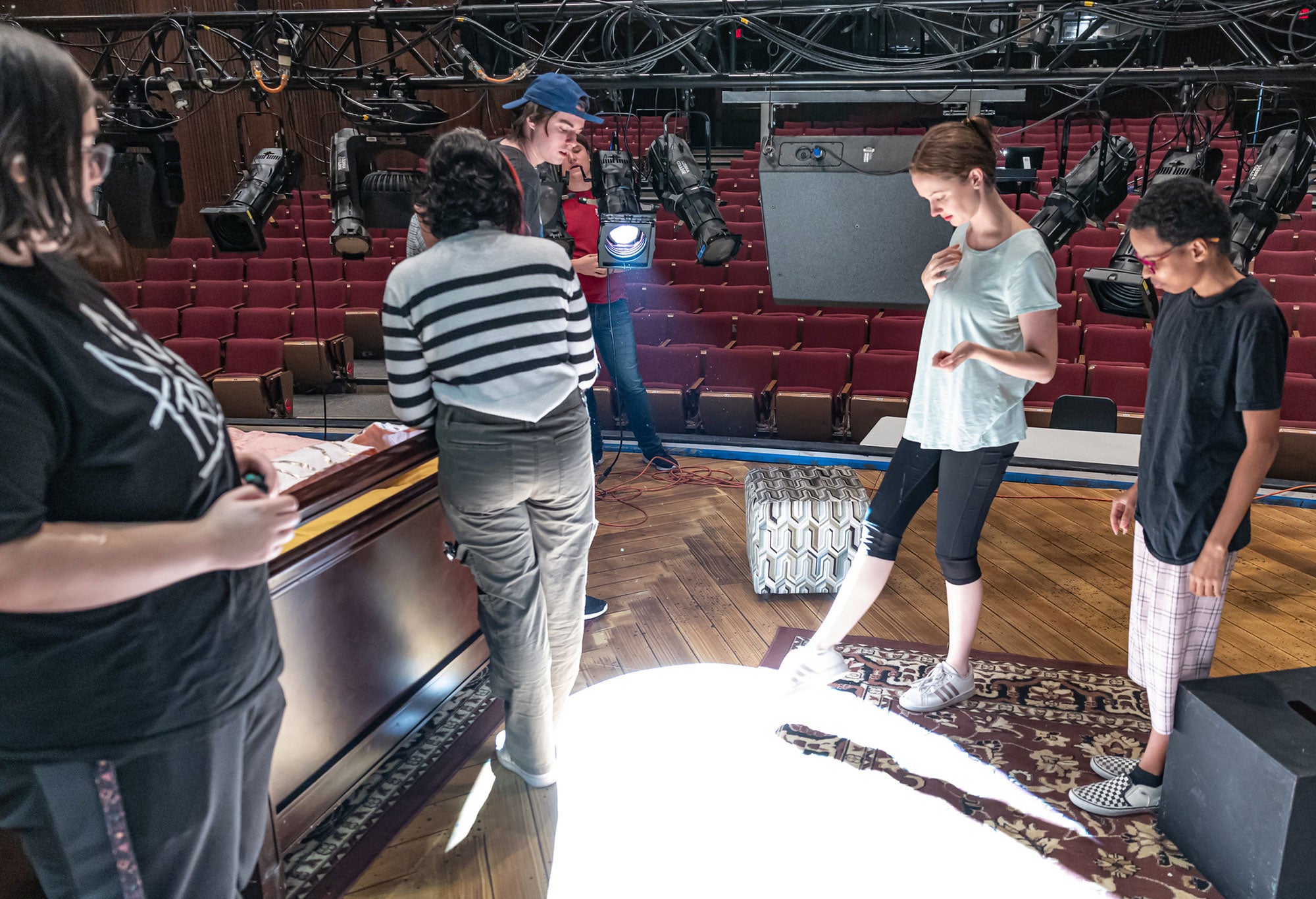 Students learning to set up and adjust stage lighting