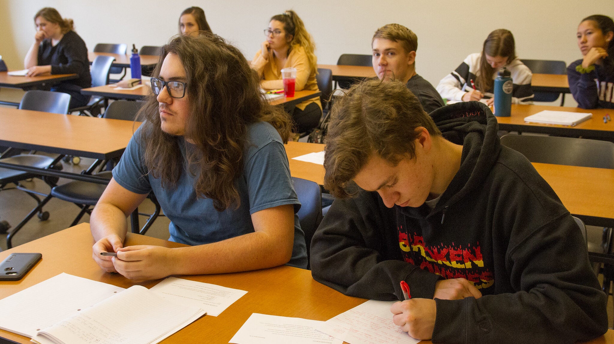 Men in classroom studying.