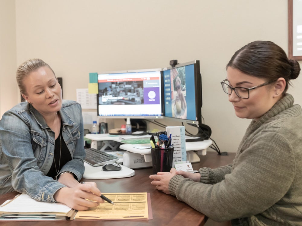 Sierra College staff member assisting a student