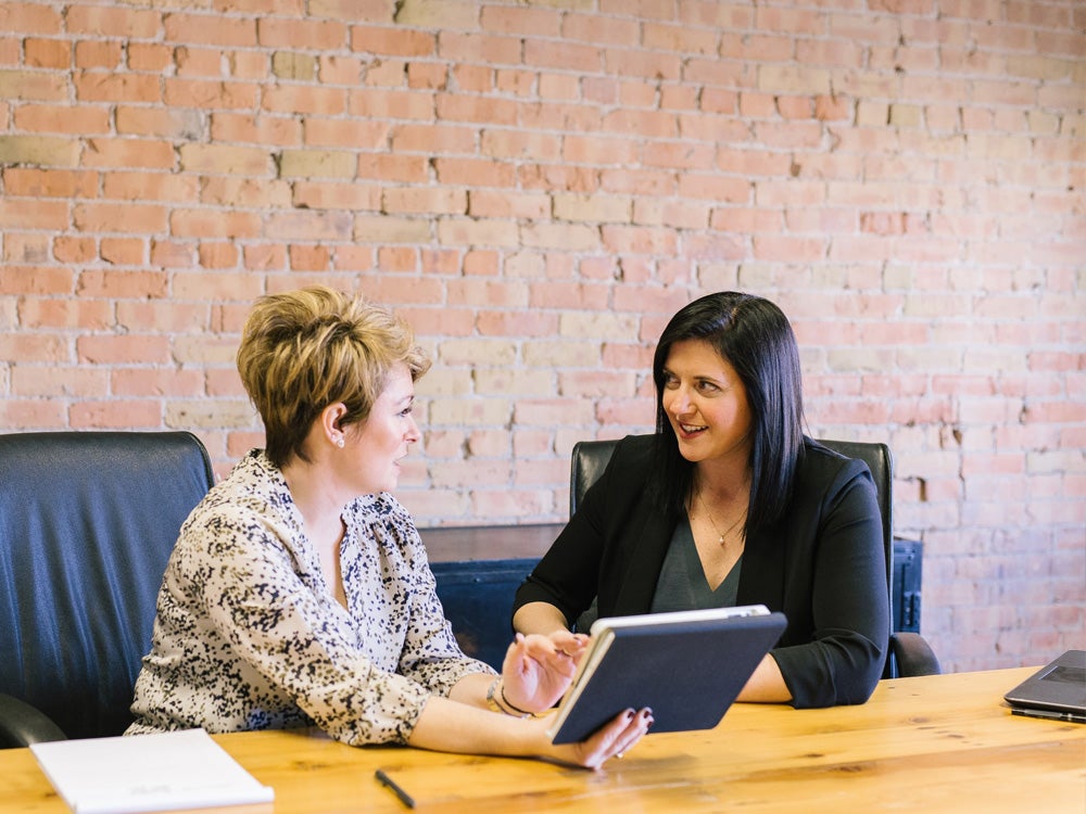 Two women sitting and speaking