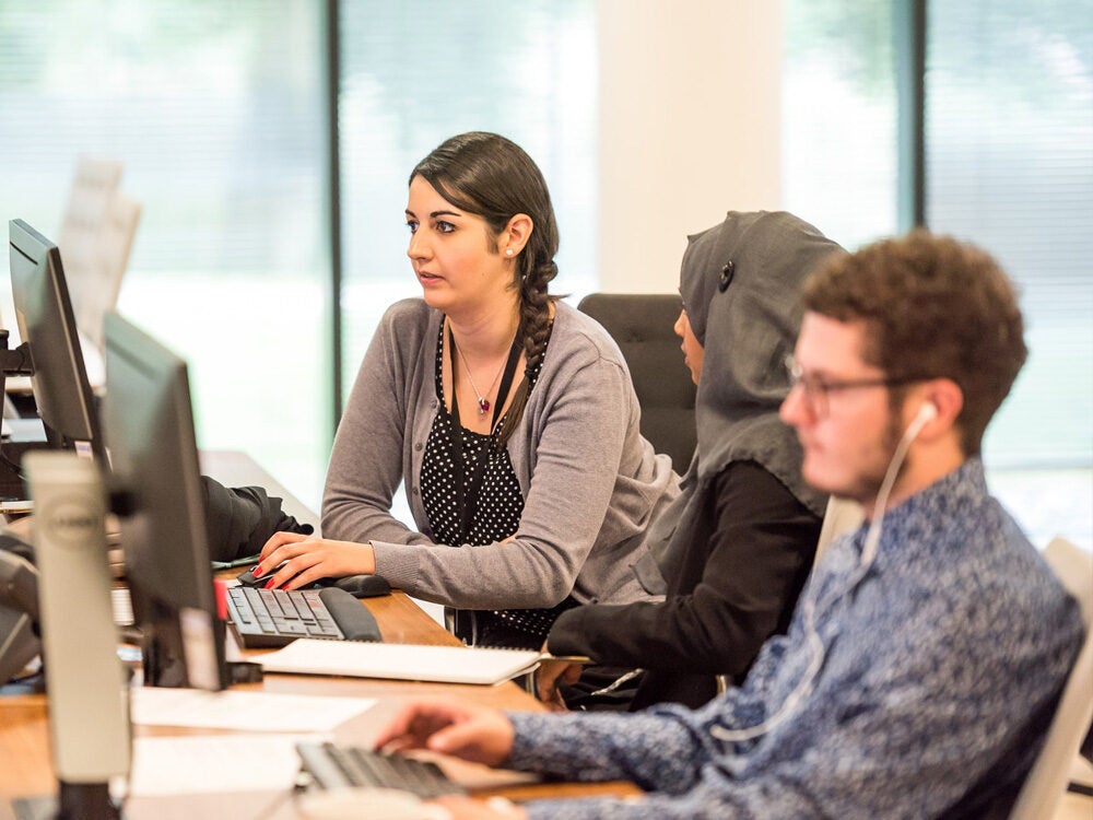 Students using computers to search for job and internship information.