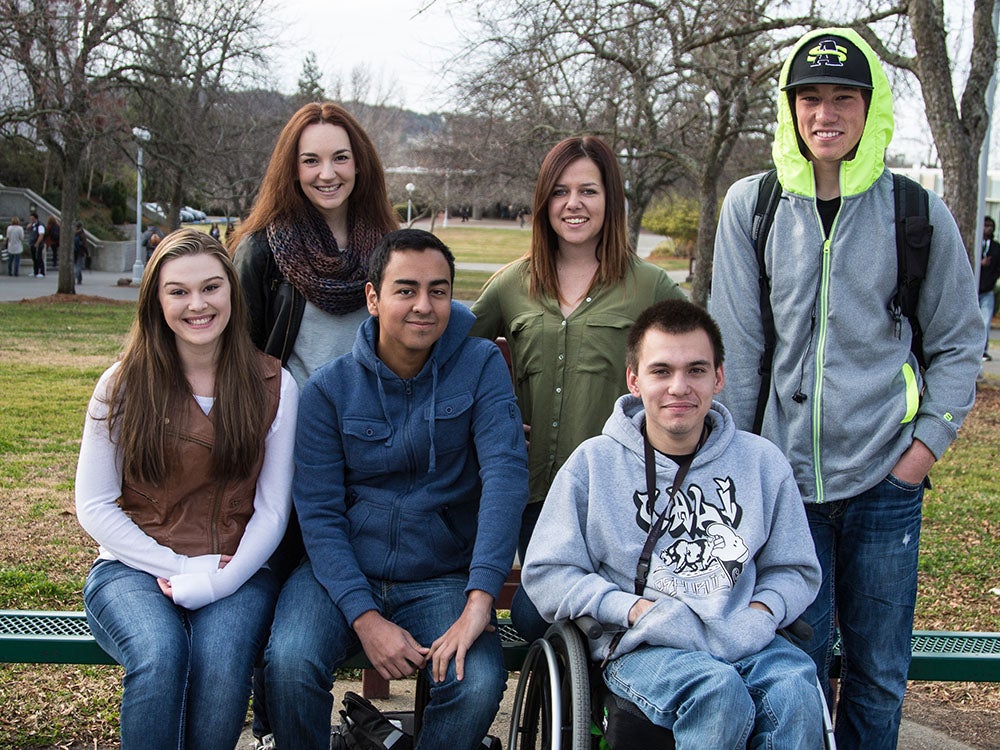 Three female students, two male students of color, one male student in a wheelchair