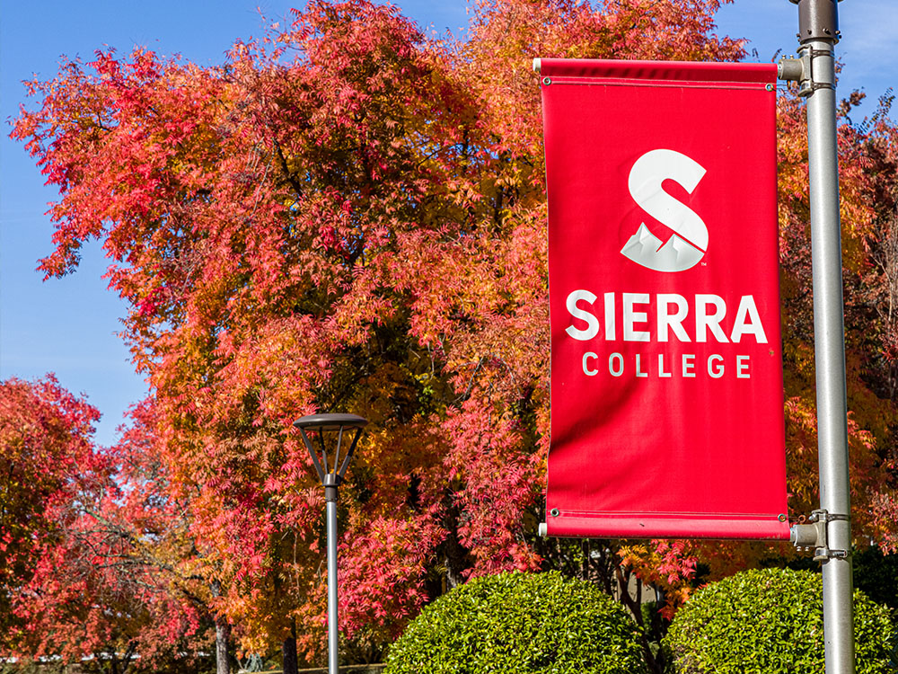Red and white Sierra College banner on Rocklin campus