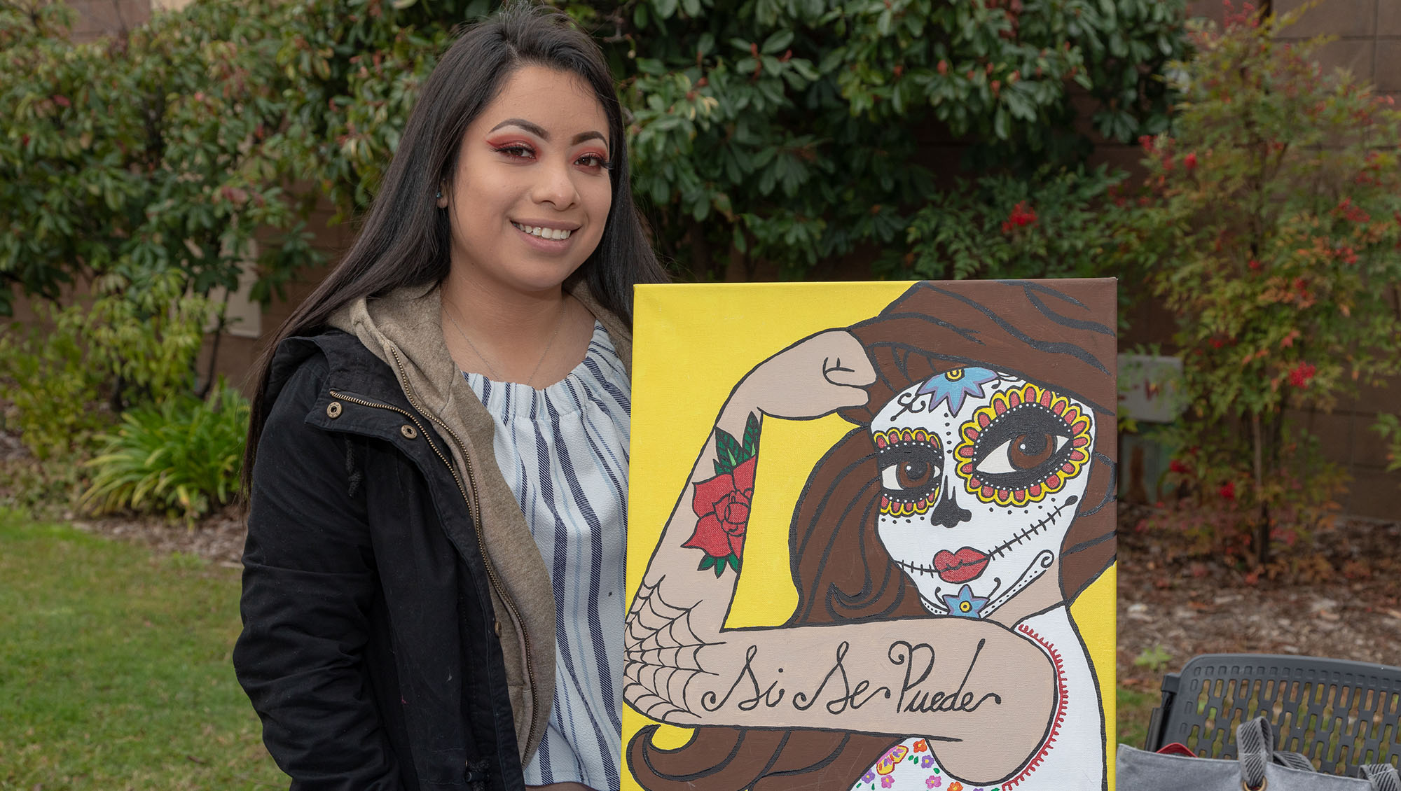 Sierra College graduate with her artwork named Si Si Puede