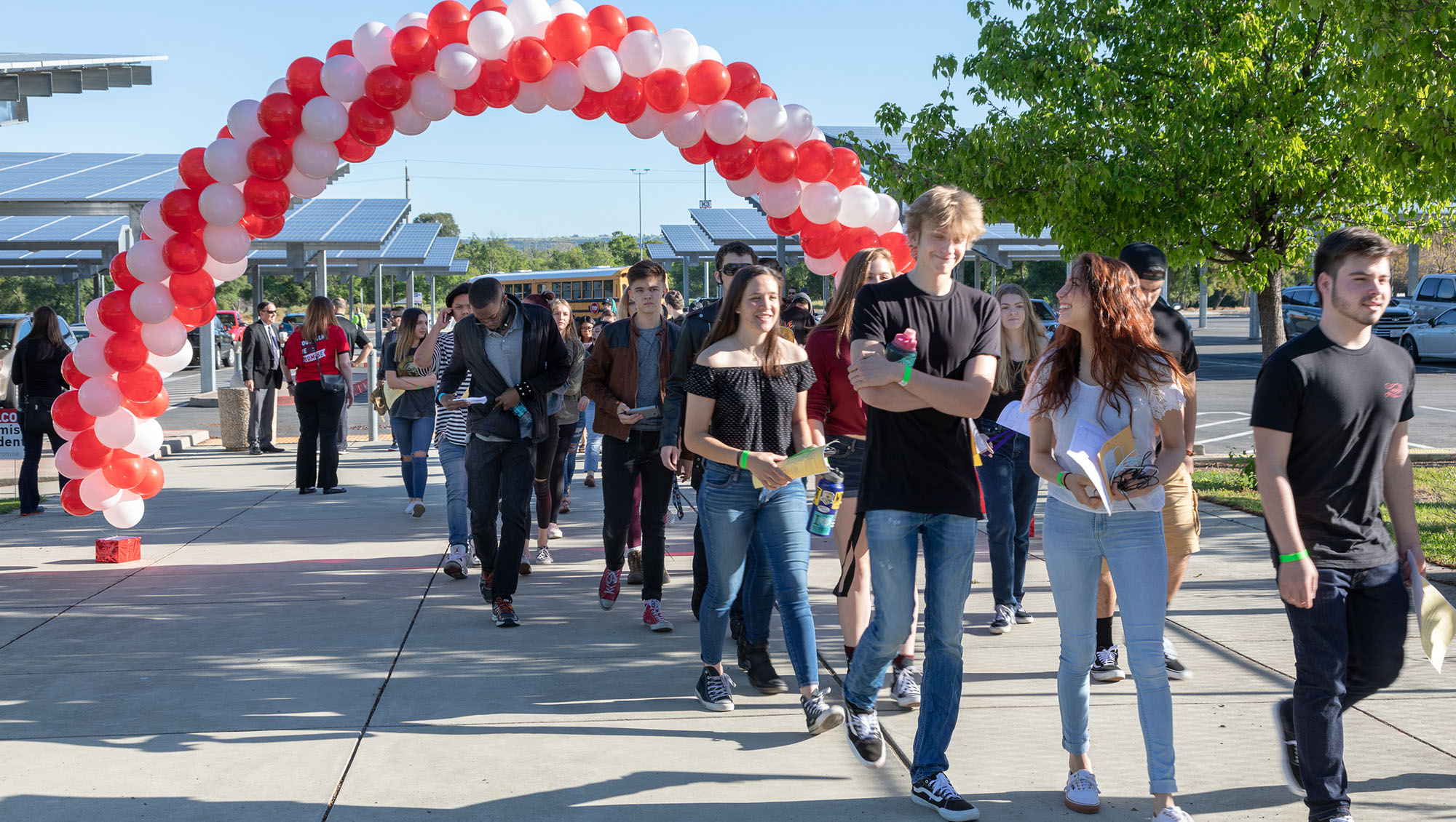 Sierra College Promise Program kickoff celebration with a procession of students walking underneath a balloon arch