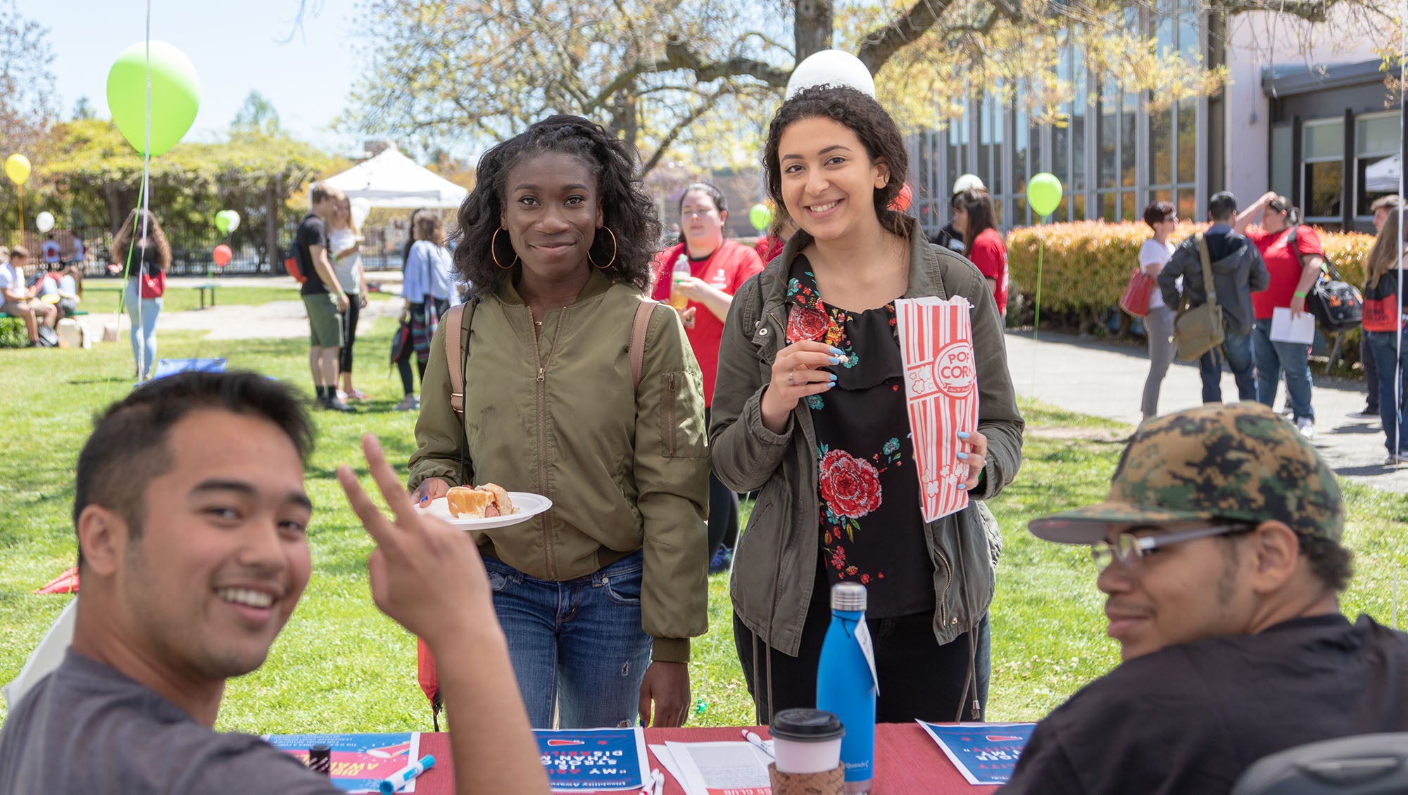 Two high school students learning about support programs from Sierra College students