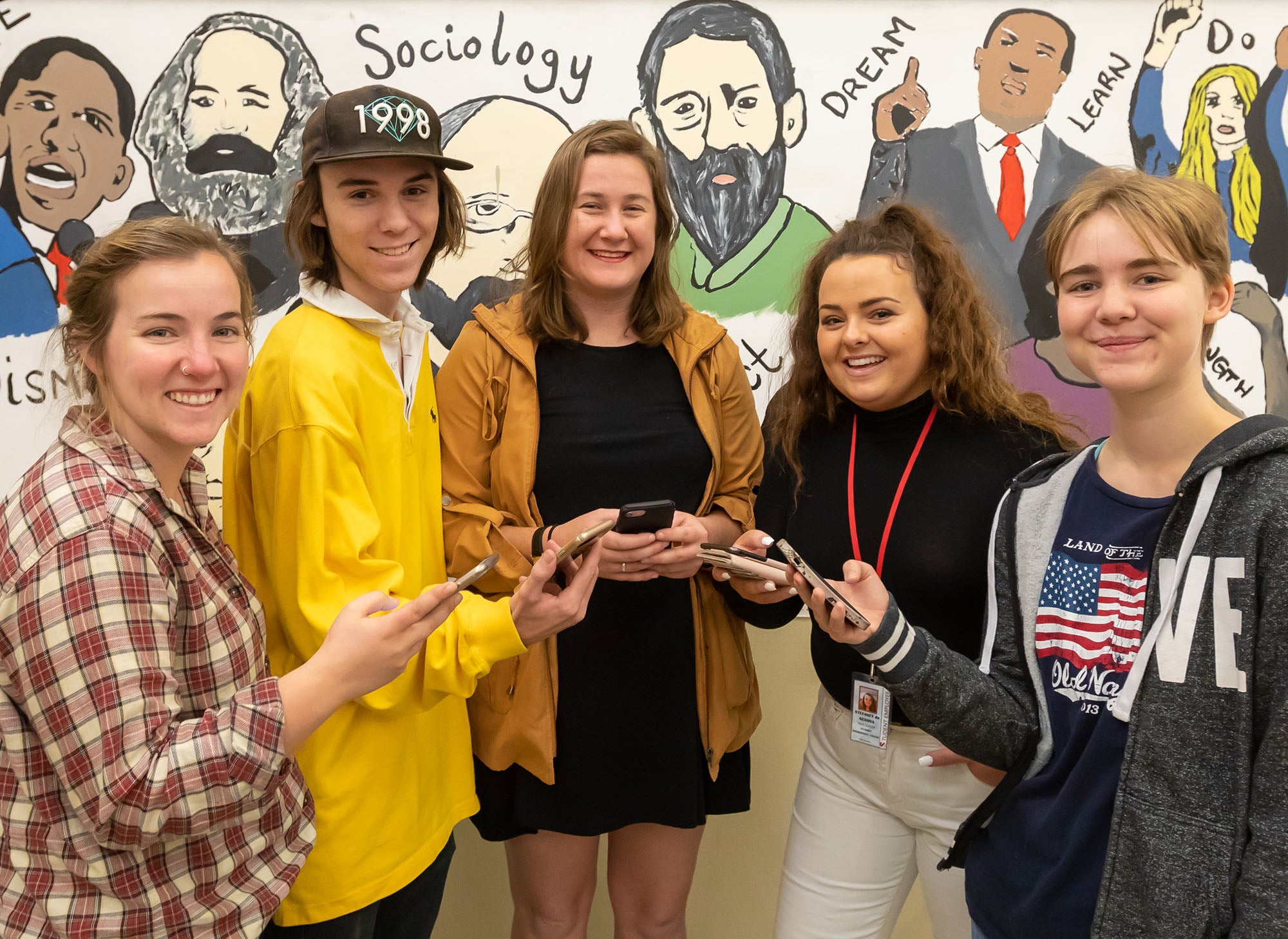 Sociology students in front of mural of activists at Sierra College