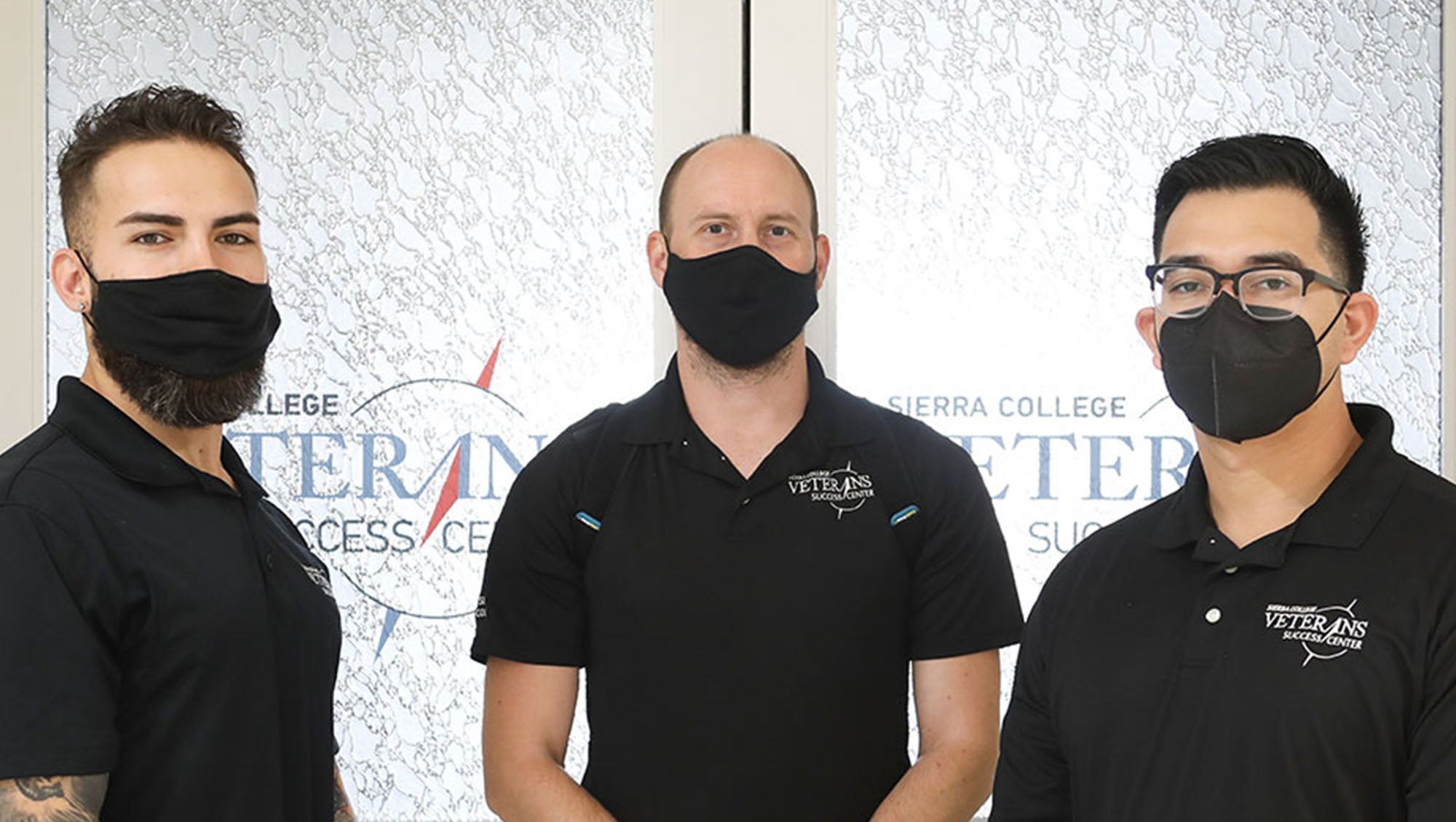 Staff standing in front of the glass doors to the Veterans Success Center at Sierra College