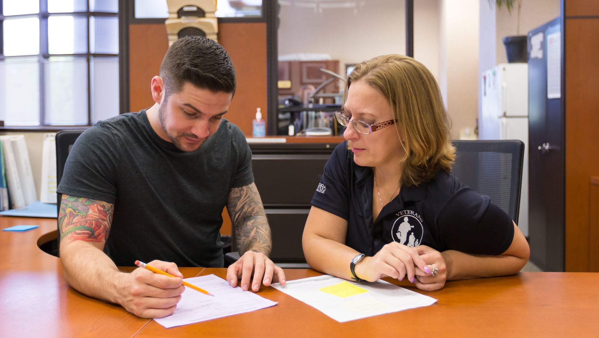 Staff helping student with paperwork at the Veterans Support Center at Sierra College