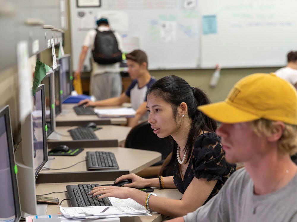 Two students is working with computers