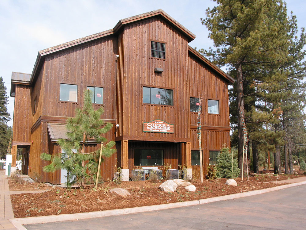 Tahoe Truckee building with pine trees around it.