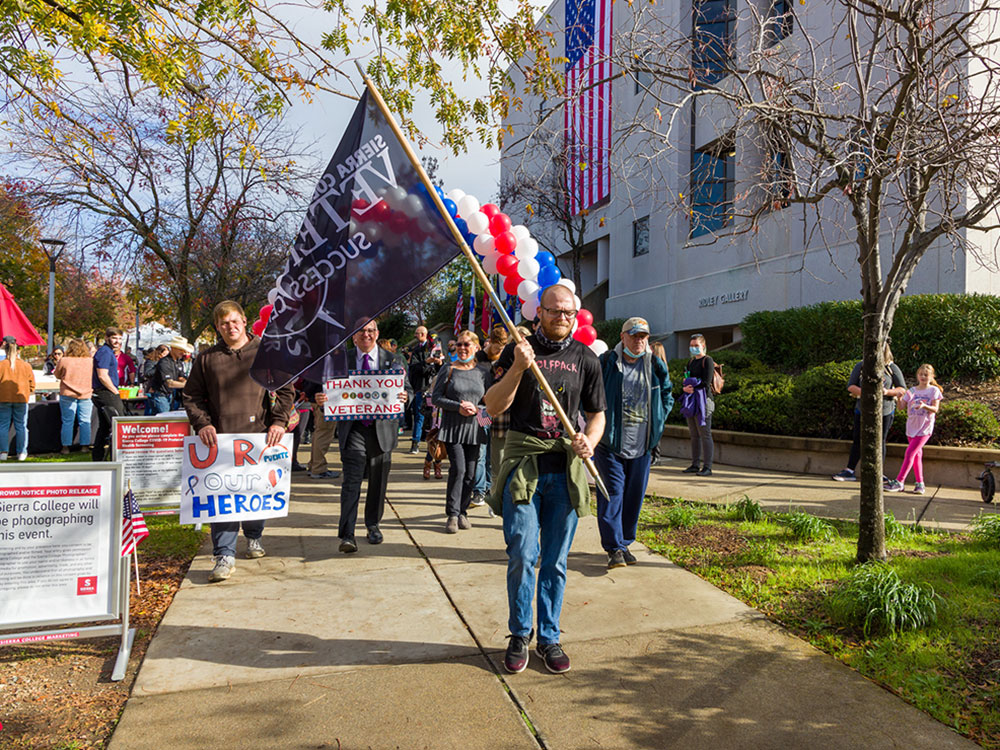Students, staff, faculty and community take a "Walk-in their Boots" as part of Veterans Day ceremony.