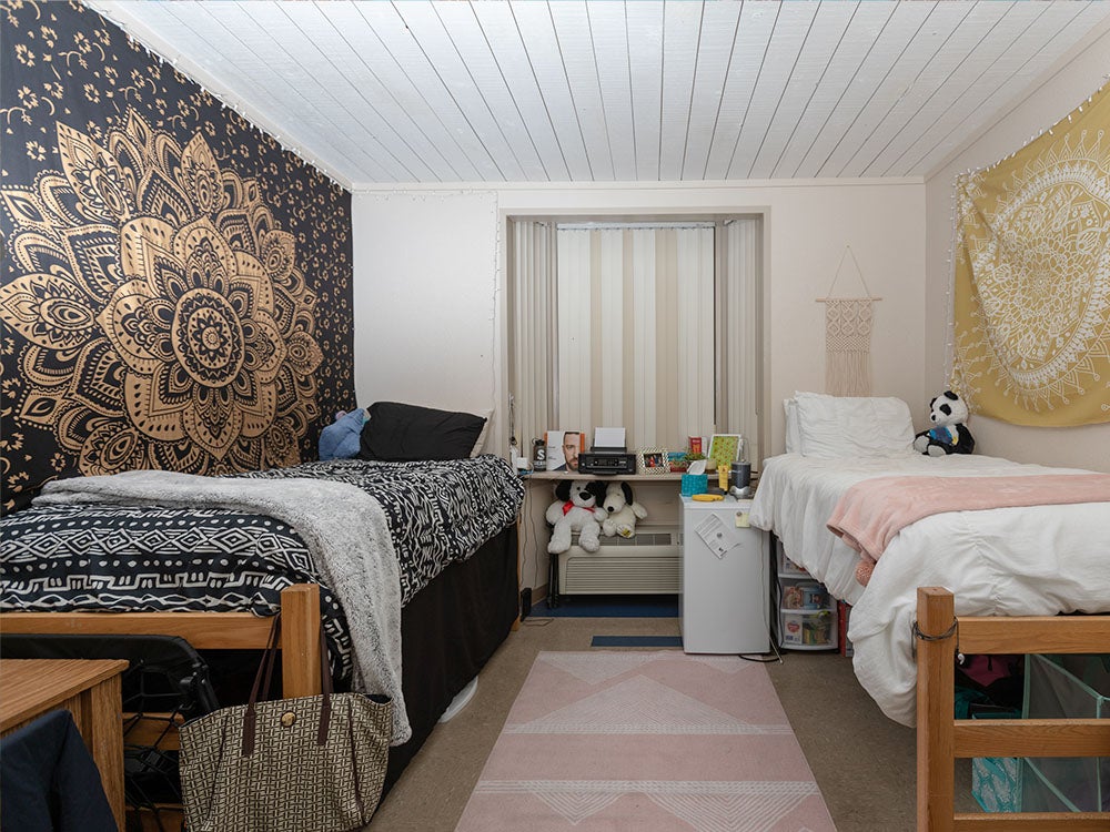 Dorm room with two raised beds in student housing on Sierra Rocklin campus