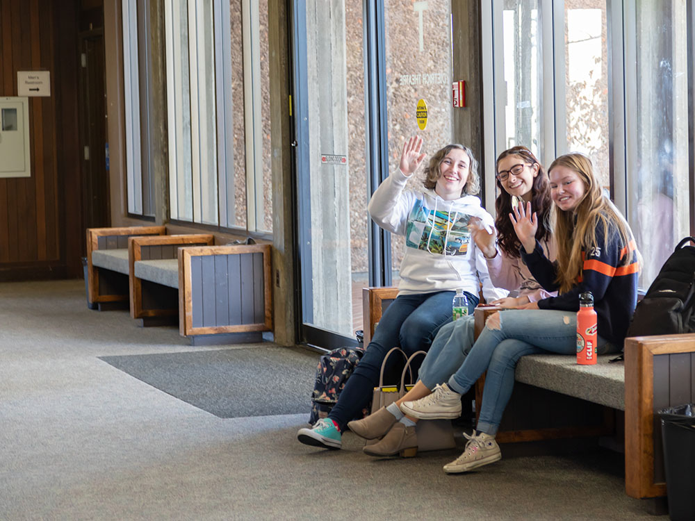 Three female students in lobby of Sierra campus building