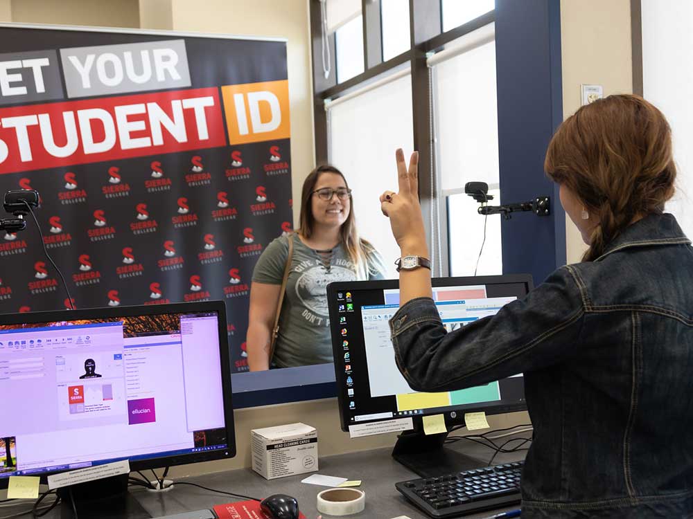 Female student posing for camera to get student ID