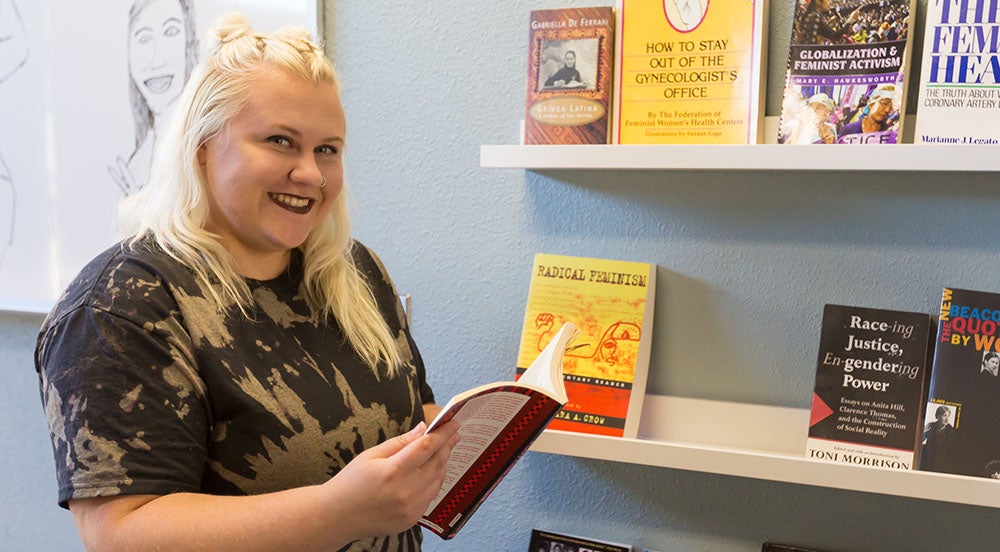 Staff with books at the Women and Gender Resource Center