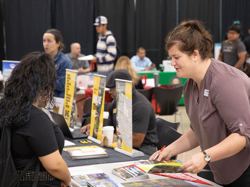 College representative speaks to a student at college transfer fair on Rocklin Campus.
