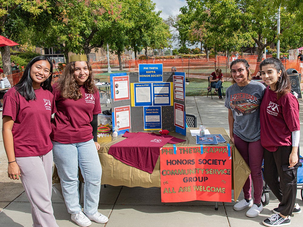 Four Phi Theta Kappa (PTK) International Honor Society students represent PTK at Club Days on Rocklin Campus.