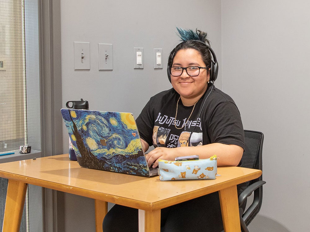 Student using a study room in the library on the Rocklin campus