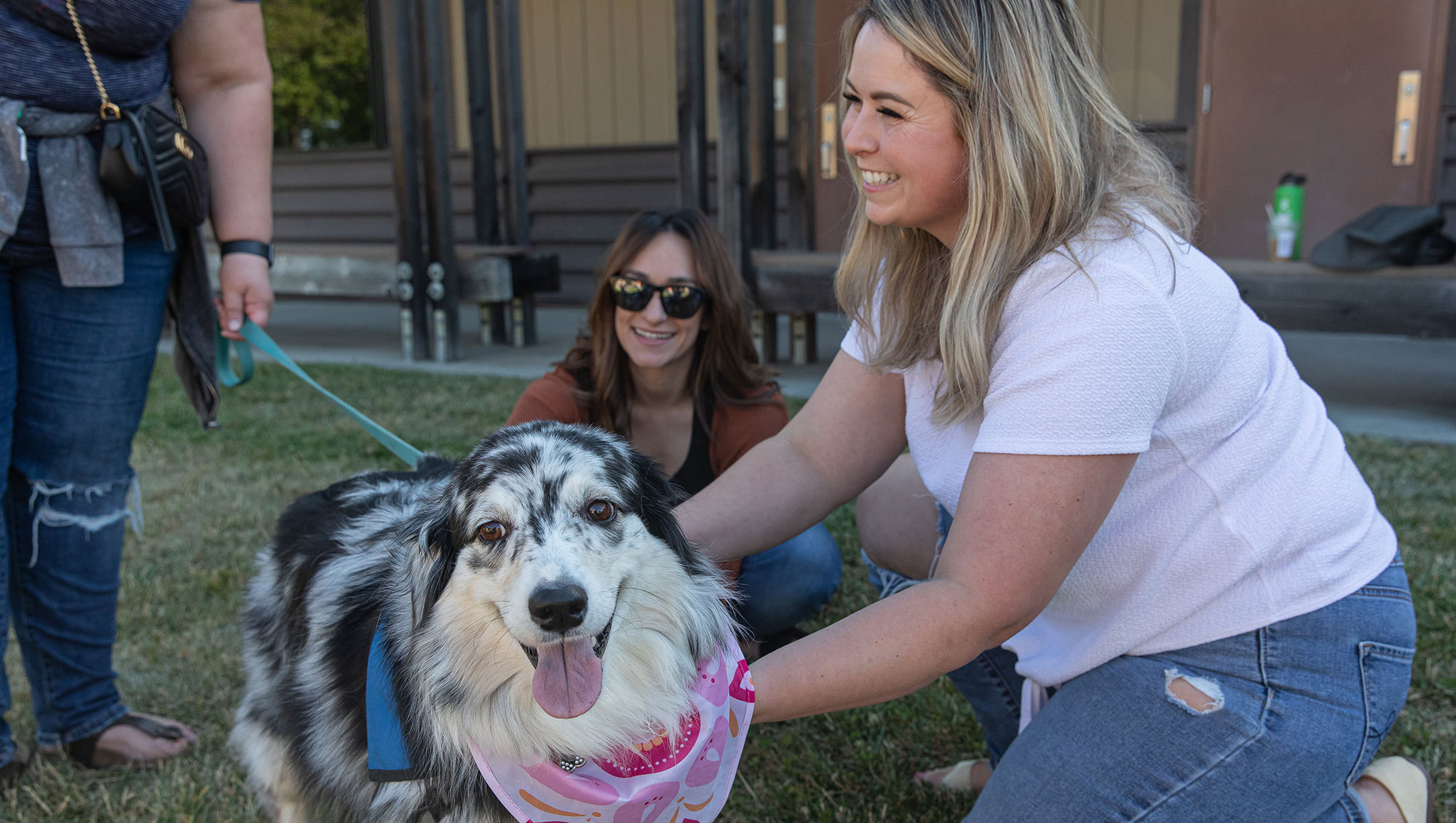 Nursing student petting therapy dog on Rocklin campus
