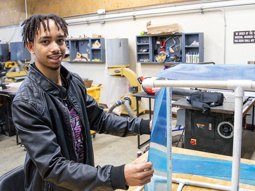 Student designing a prototype in the Makerspace for an entrepreneurship project