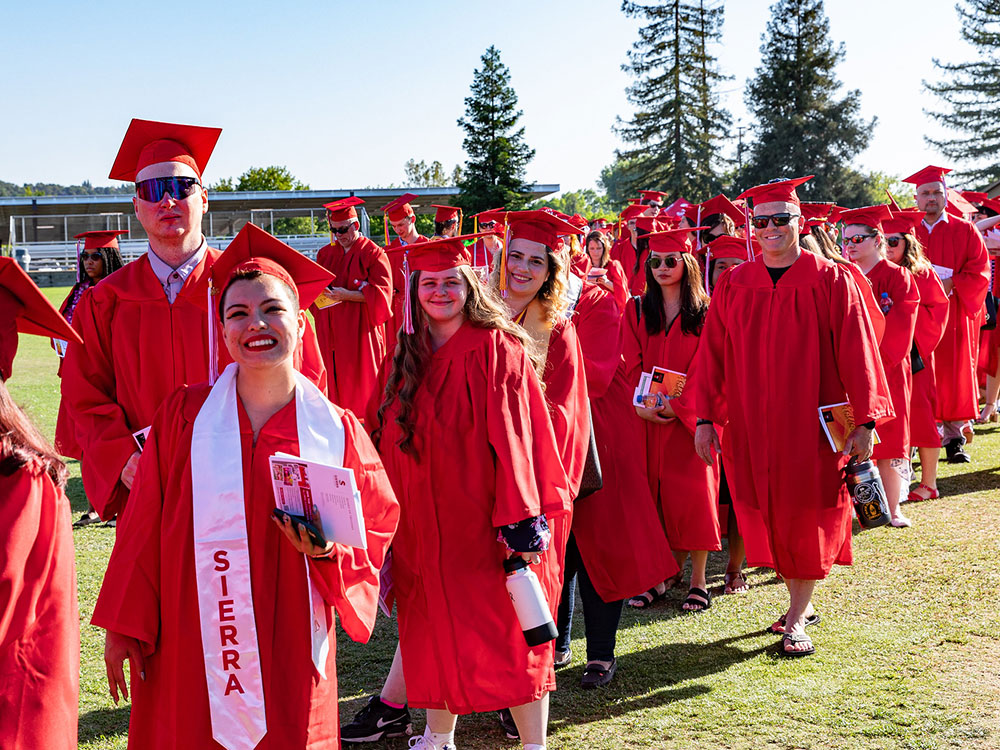 Graduates wearing red cap and gowns at Rocklin ceremony