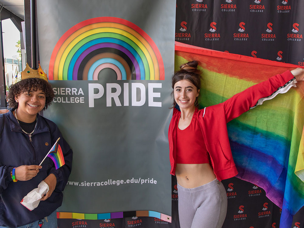 Two students holding Pride flag