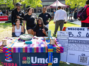 Ten Black students gathered together at the Umoja booth during Wolverine Week