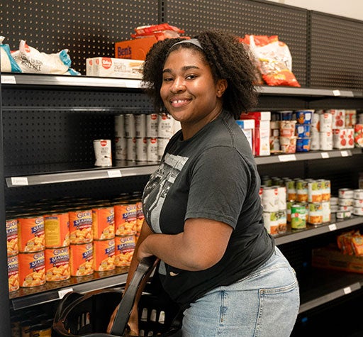 Student picking out free food from the Basic Needs Center