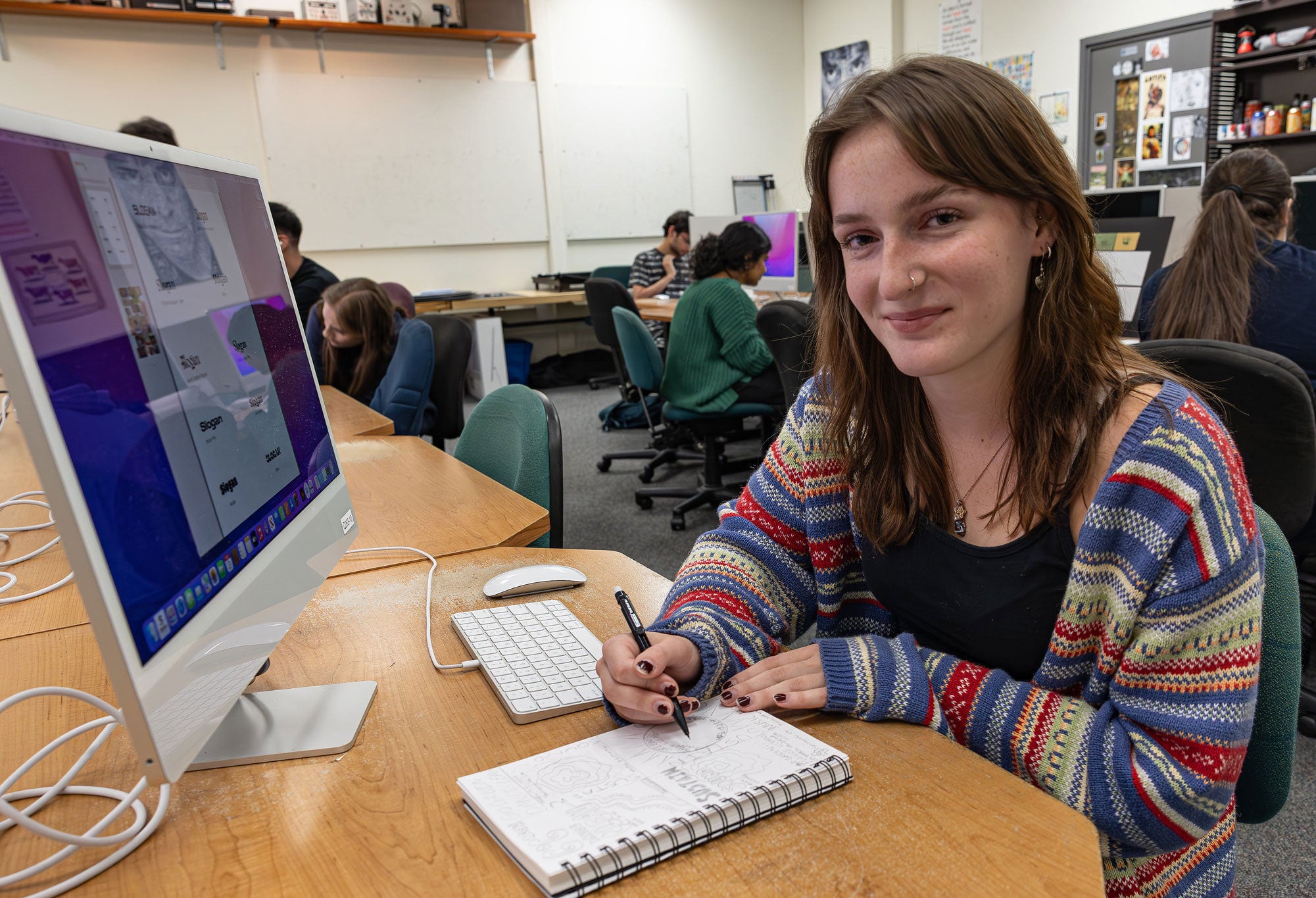 Woman at computer designing an art piece.