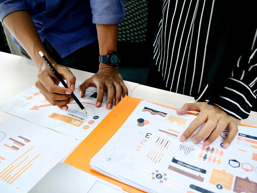 A person hand is making plans on a board