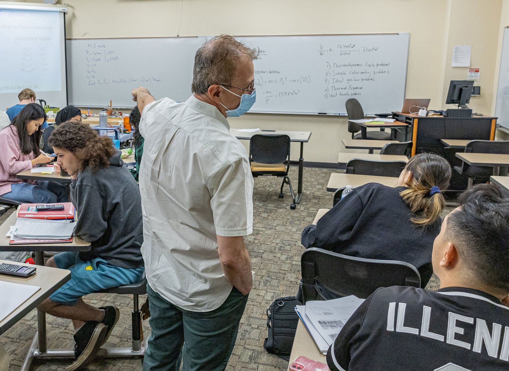 Physics instructor explaining concepts to students