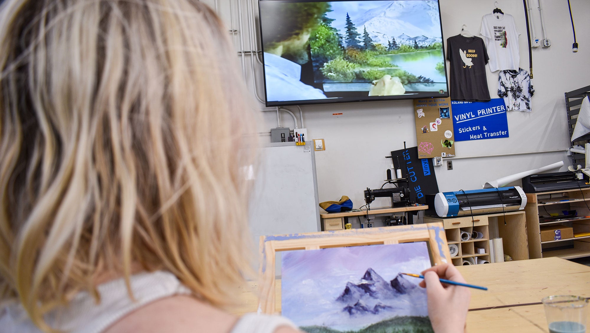Makerspace Student Painting Bob Ross Scene
