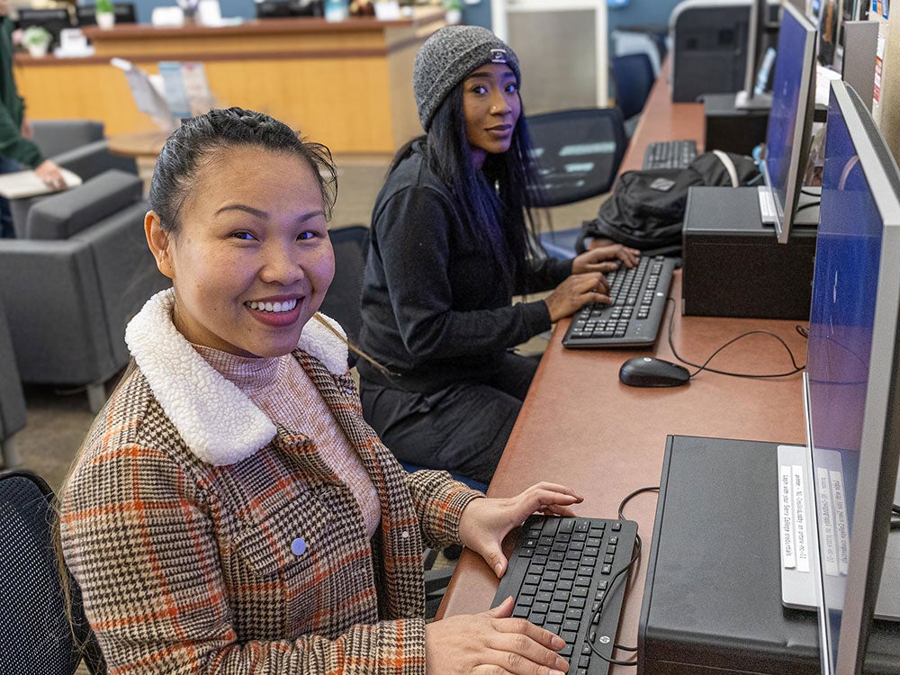Two students using computers at NCC
