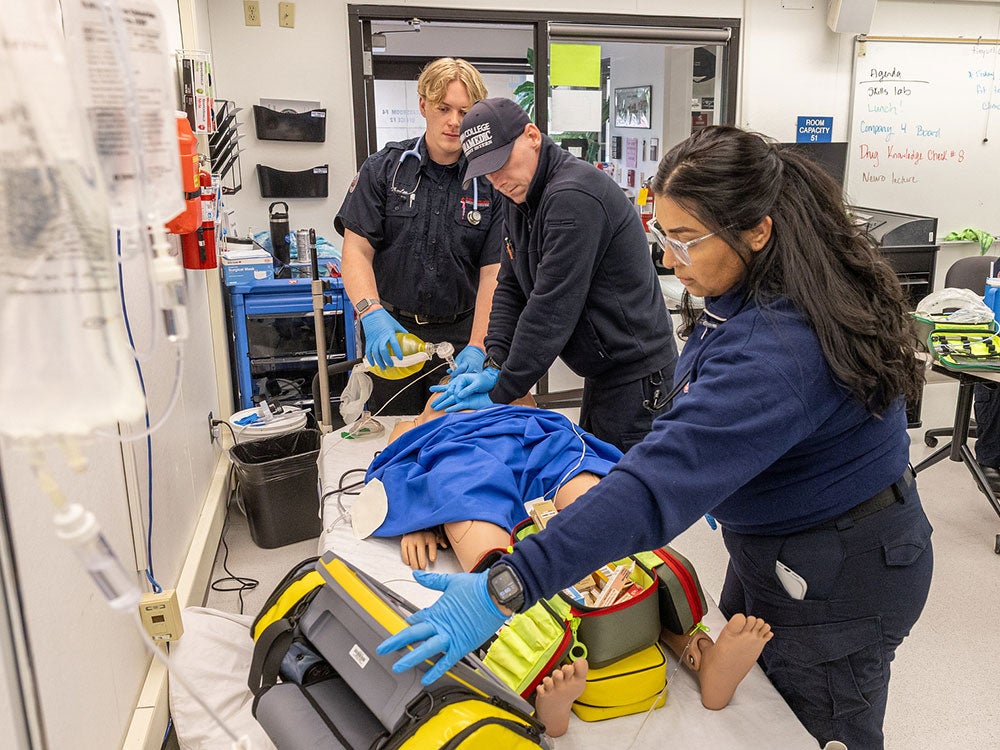 Paramedic students receive training in classroom with instructor.