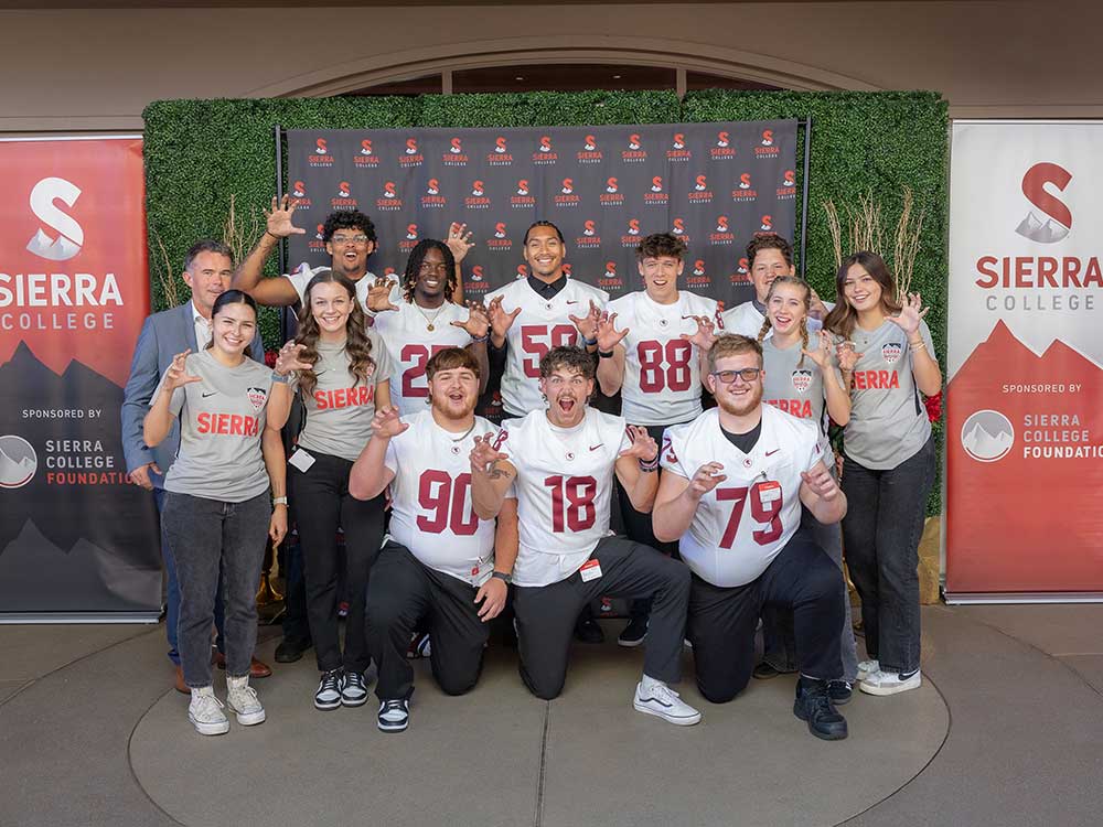 Sierra College Athletics coach and team members are claws out