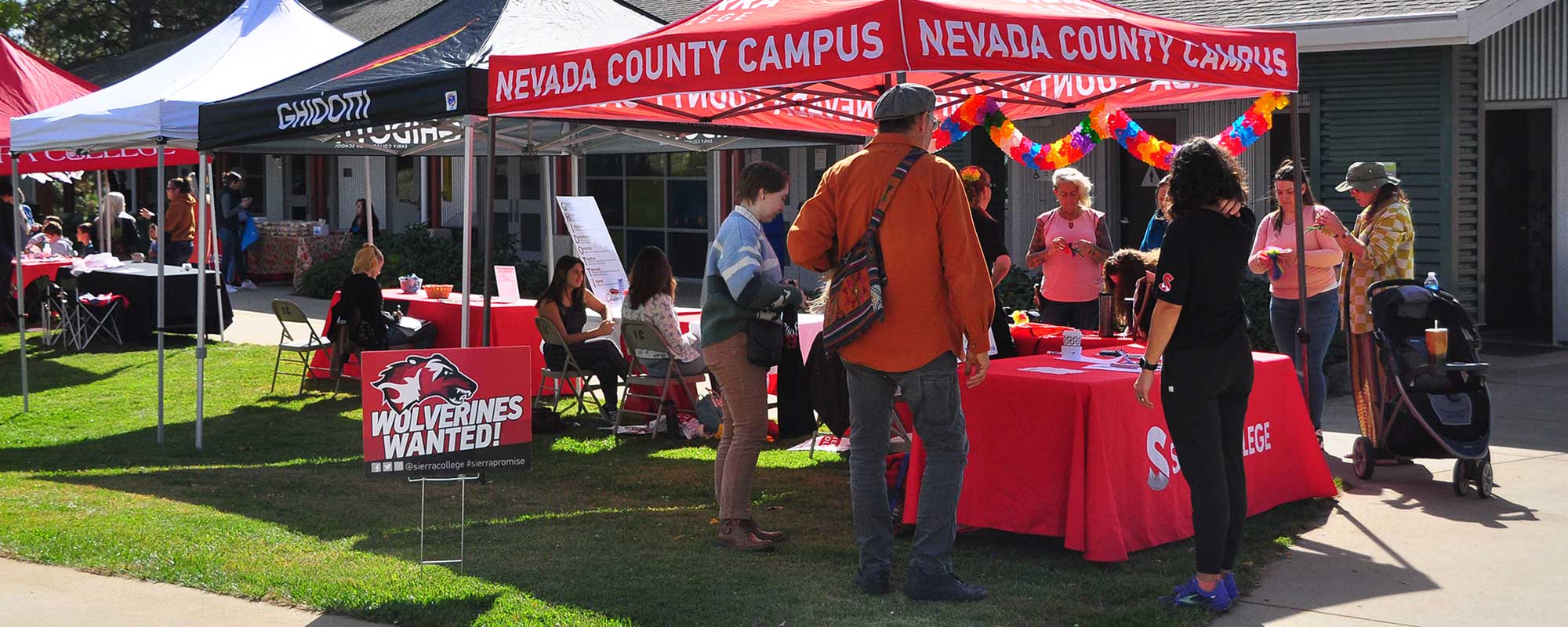 People visiting information booths at NCC