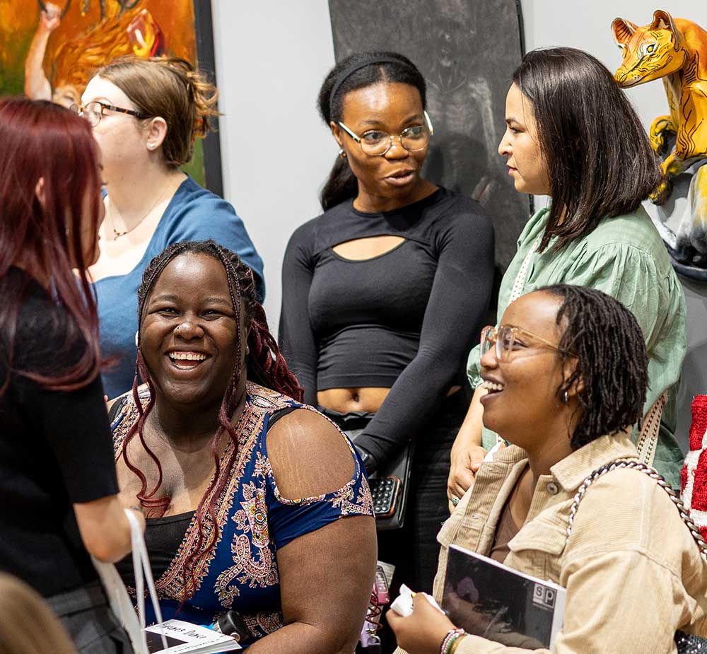 Group of students chatting in Ridley Gallery