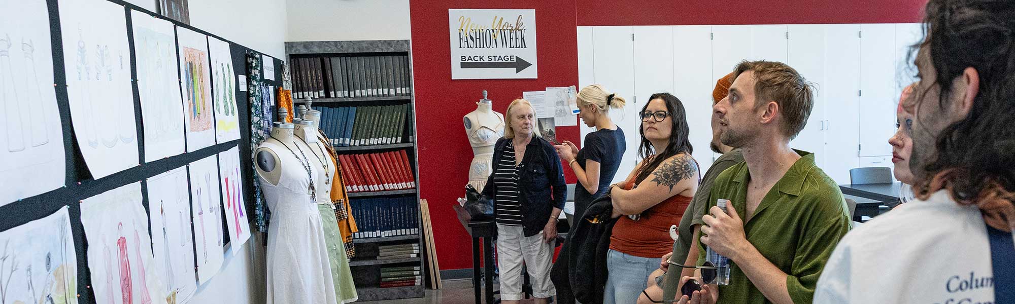 Visual and Performing Art event attendees review fashion sketches