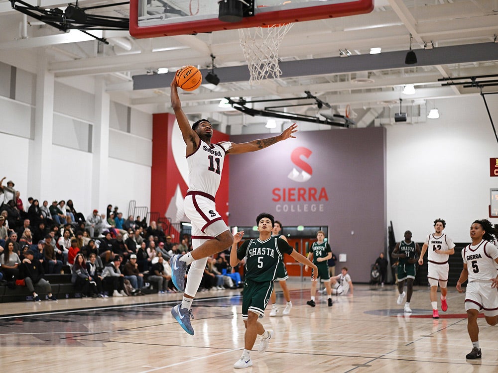 Sierra College basketball player #11 goes for slam dunk