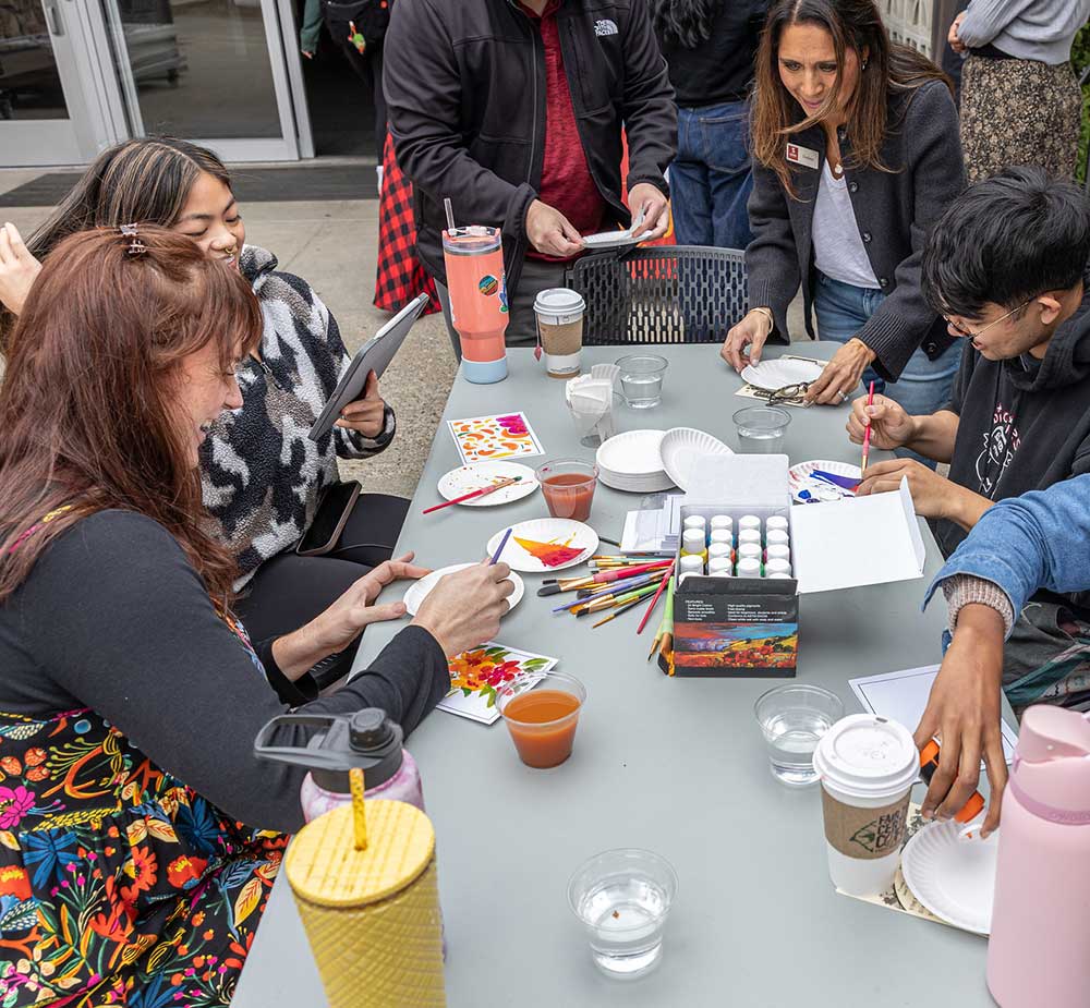 Students learning Asian-inspired painting techniques